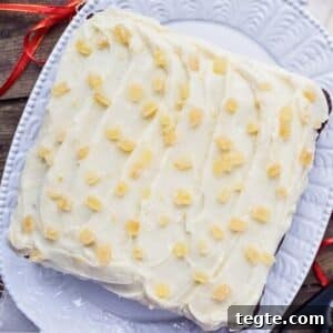 One-layer gingerbread cake with cream cheese frosting on platter.