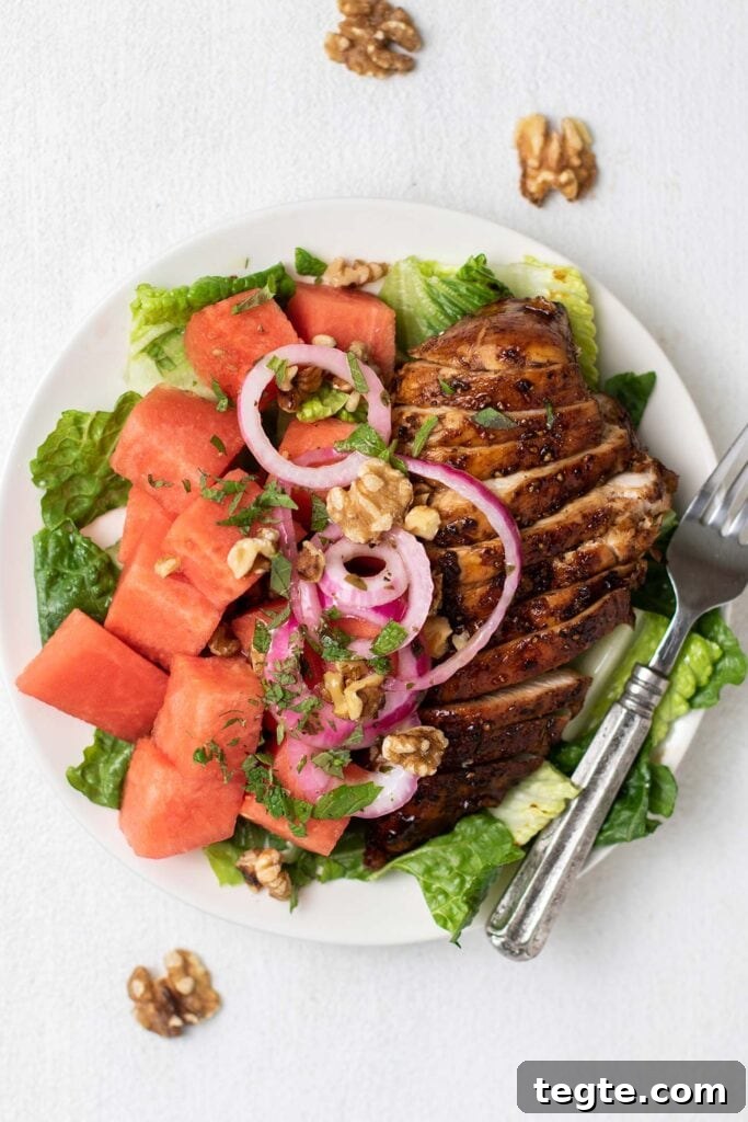 Balsamic Chicken with Watermelon Salad Recipe for Summer 2 A white plate with lettuce, watermelon, and balsamic chicken.