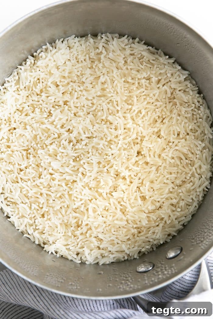 Perfect Basmati Rice on the Stove: Fluffy, No Rice Cooker Needed 4 Perfectly cooked basmati rice just before being fluffed with a fork.