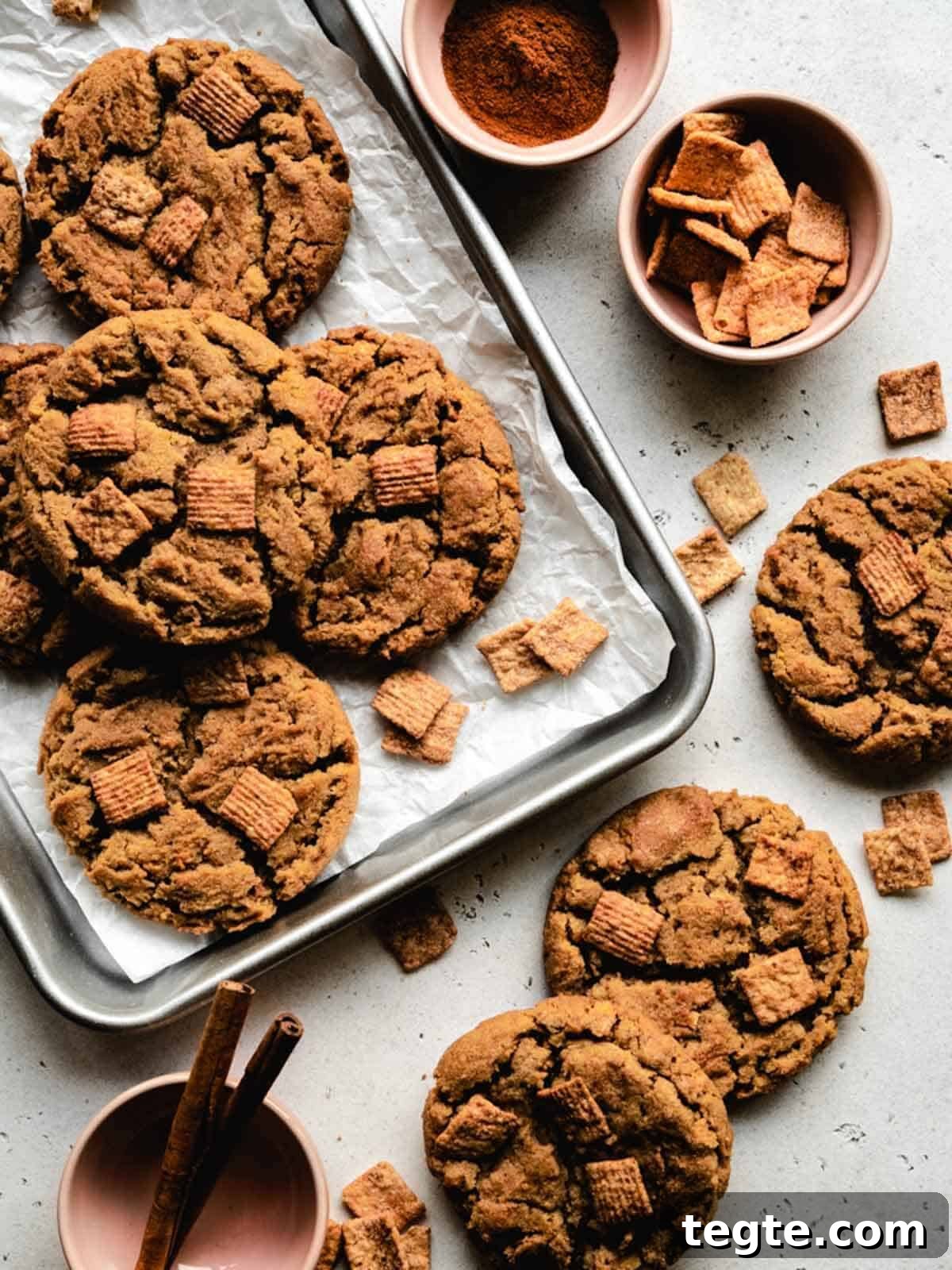 Freshly baked cinnamon toast crunch cookies on a baking tray.