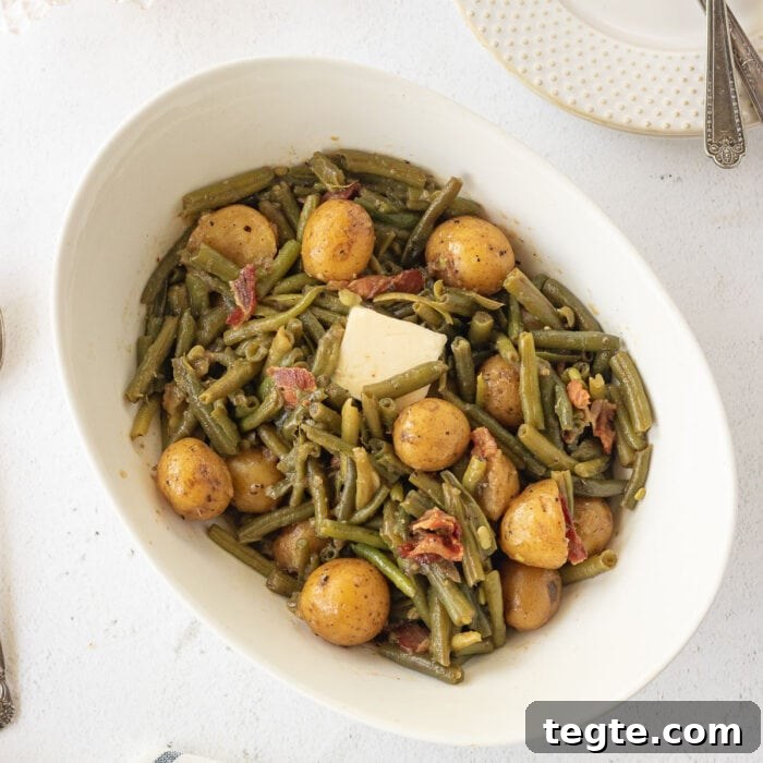 7-Day January Meal Plan: Simple Recipes for the New Year 11 Overhead view of green beans and potatoes in a serving dish with a pat of butter melting on top.