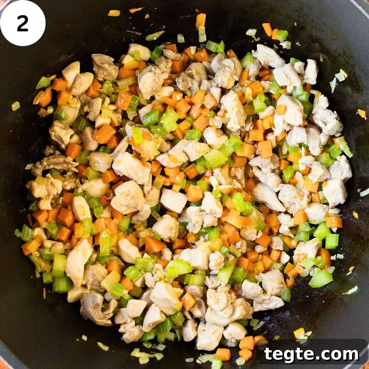 Hearty Homemade Chicken and Vegetable Soup Recipe 5 Chopped boneless and skinless chicken and diced mixed vegetable in a saucepan.