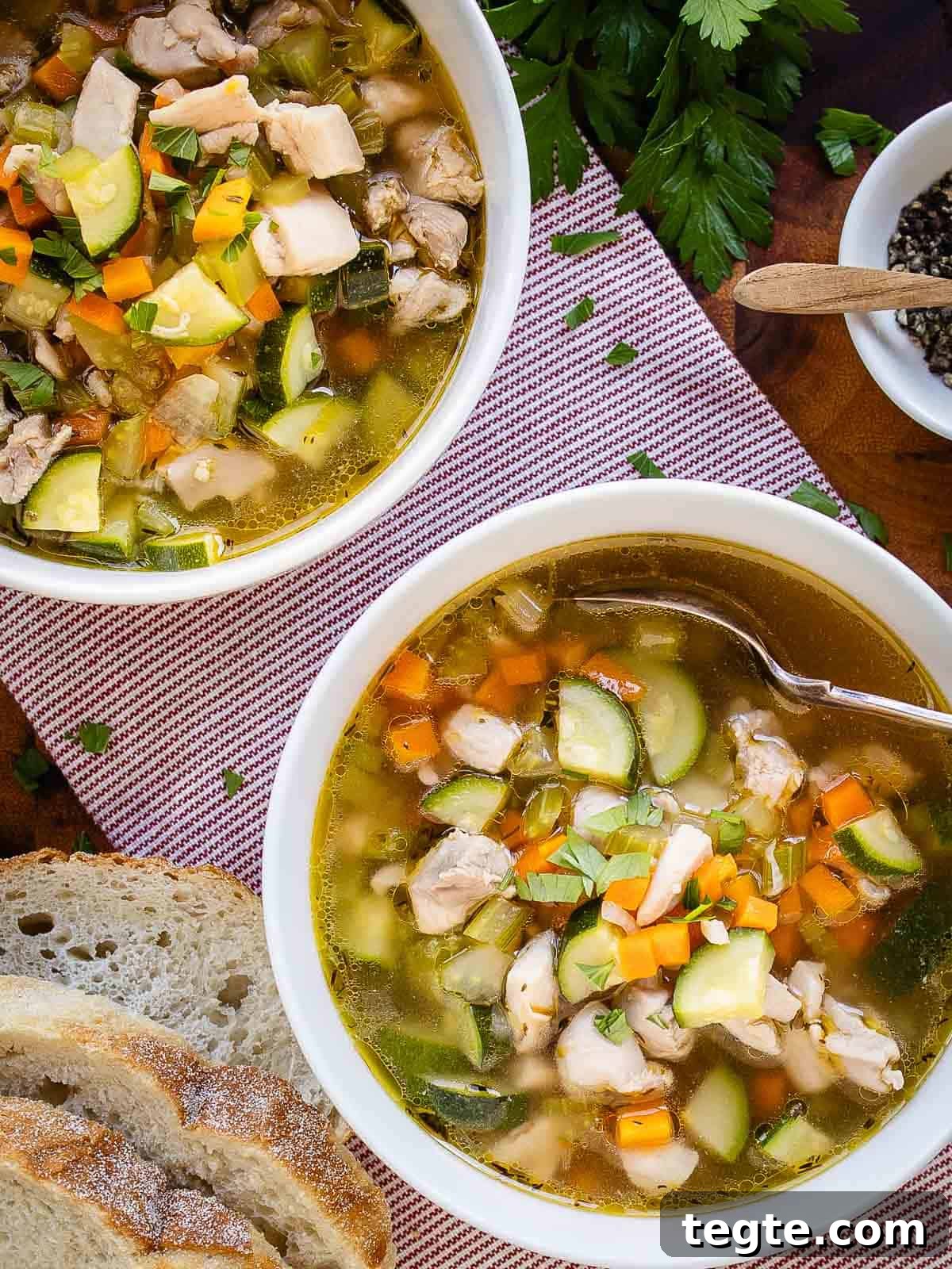 Hearty Homemade Chicken and Vegetable Soup Recipe 8 Two bowls of vegetable and chicken soup viewed from above.