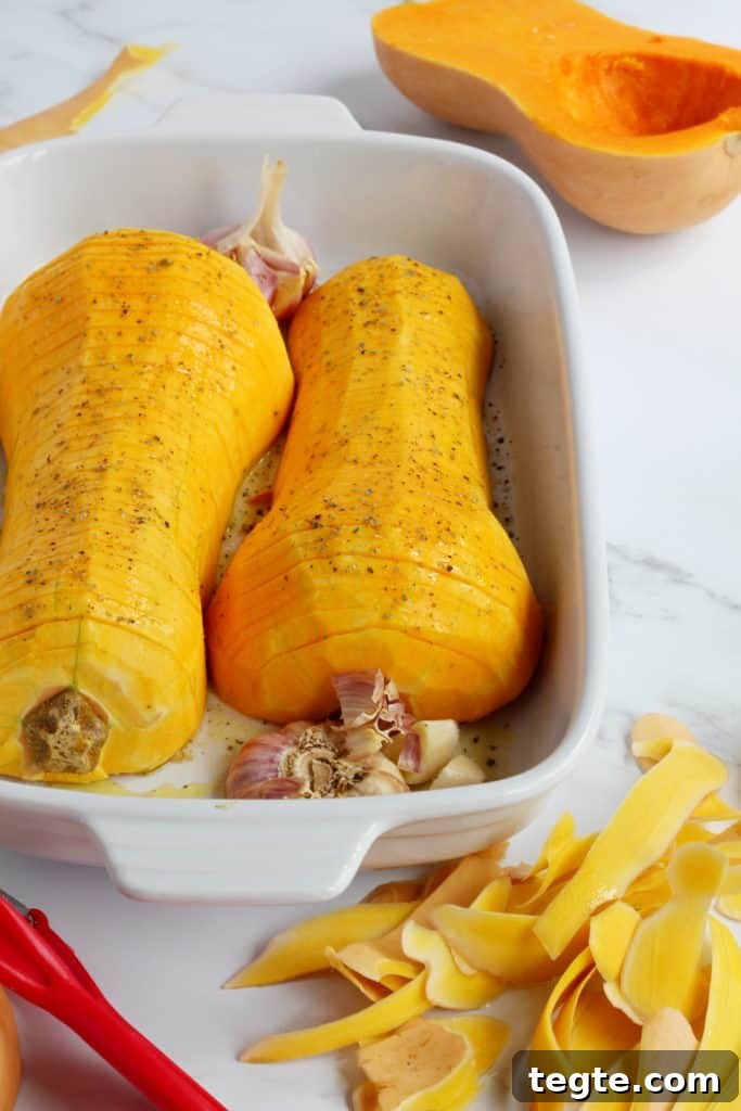 Crispy Roasted Hasselback Butternut Squash Recipe 4 butternut squash cut in half and sliced thinly and placed in white ceramic baking sheet