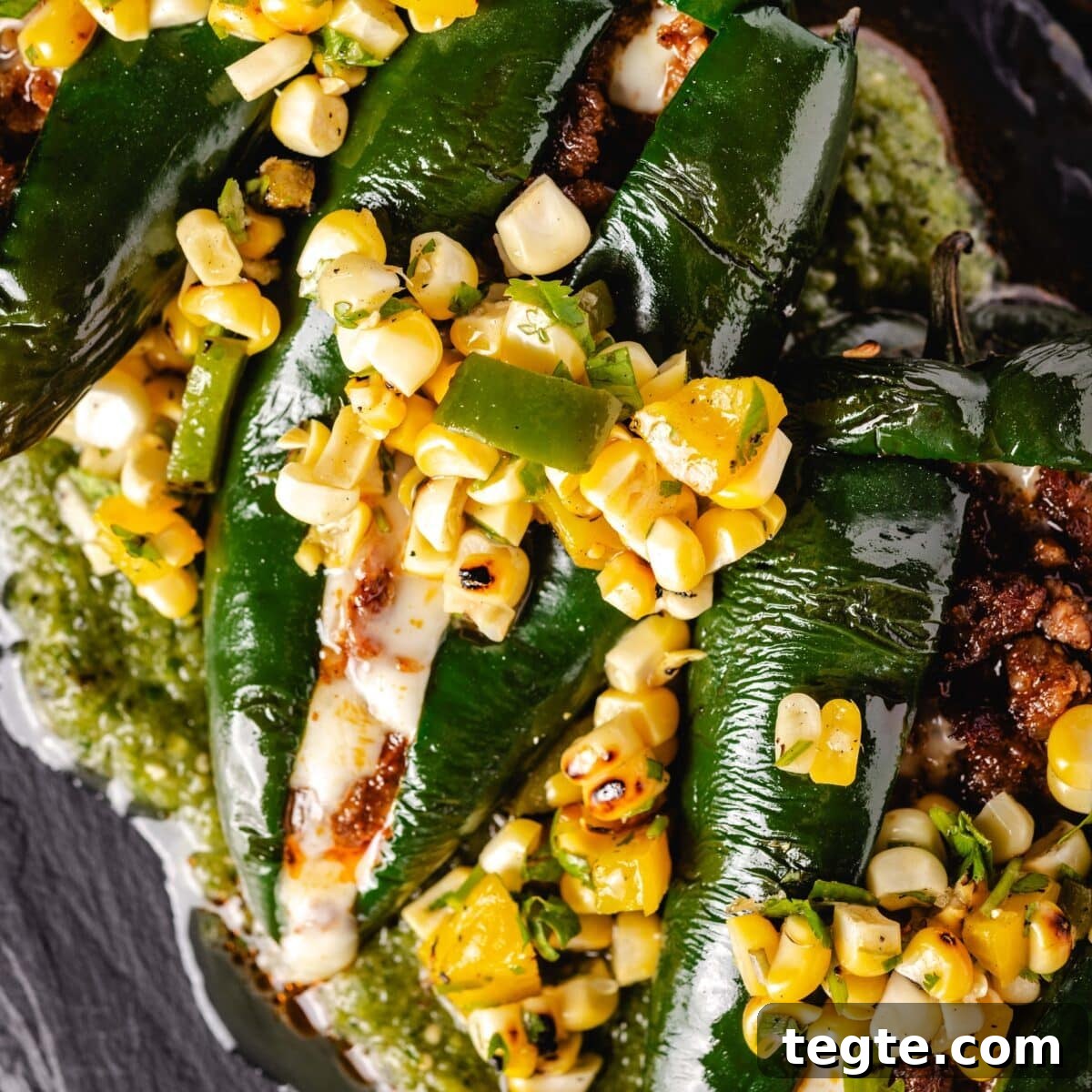 14 Pepper Recipes to Turn Up Flavor on Your Grill 4 Two stuffed, grilled Chile relleno peppers topped with corn salsa on a bed of salsa verde.