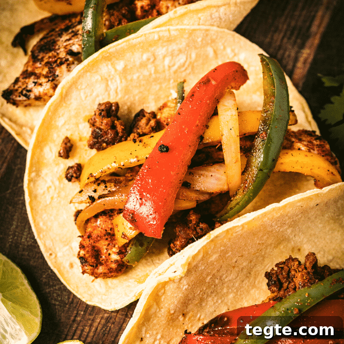 14 Pepper Recipes to Turn Up Flavor on Your Grill 6 Three grilled chicken fajitas on a wooden serving board.