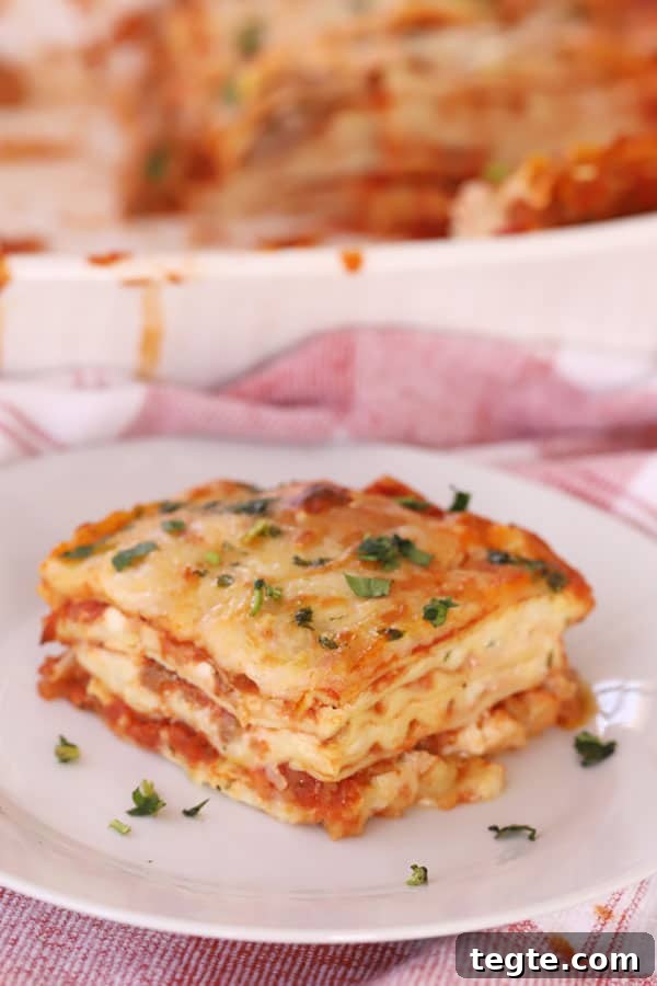 A slice of this simple lasagna recipe on a plate, ready to be served.