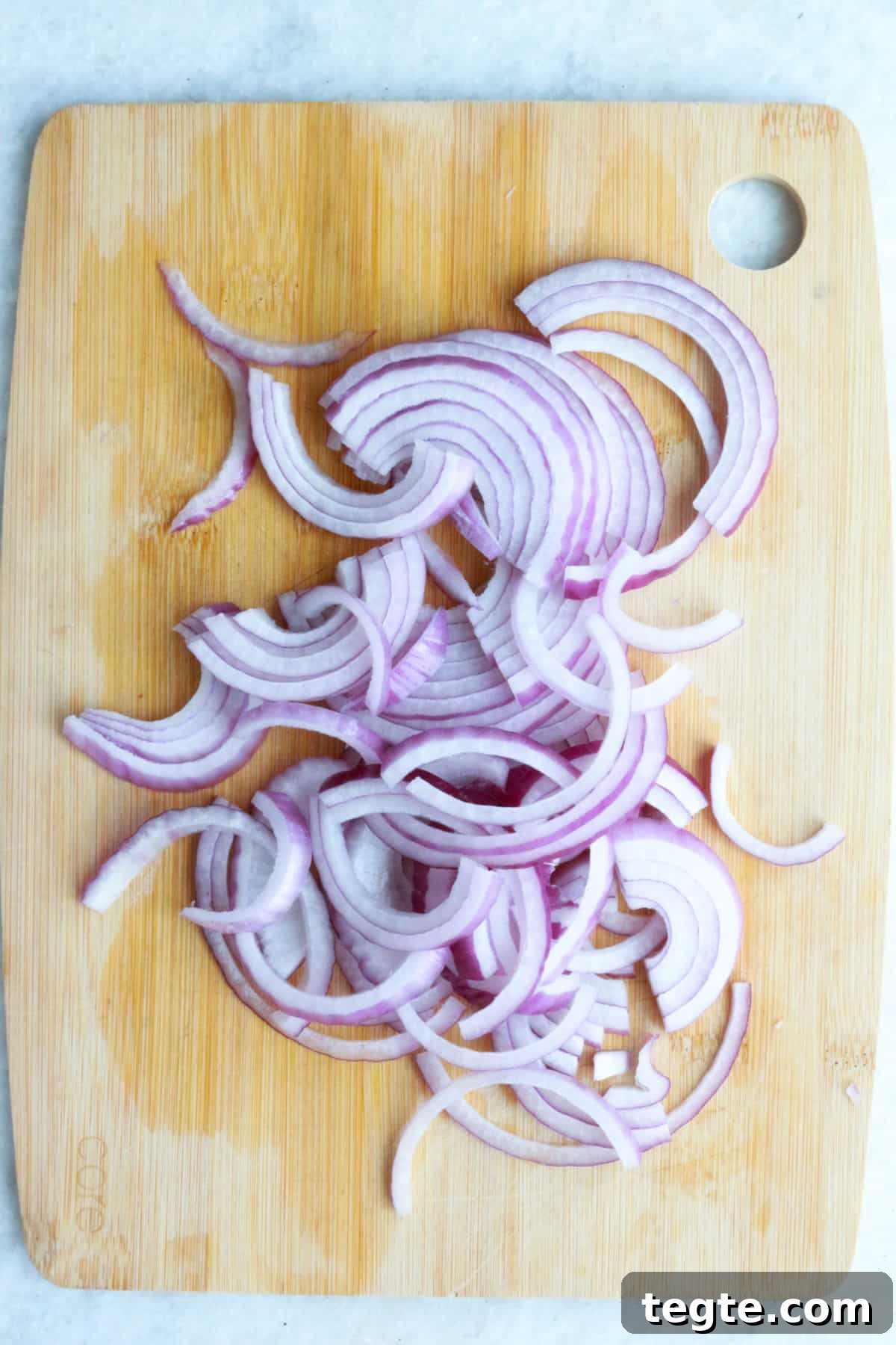 Sliced red onions on a cutting board