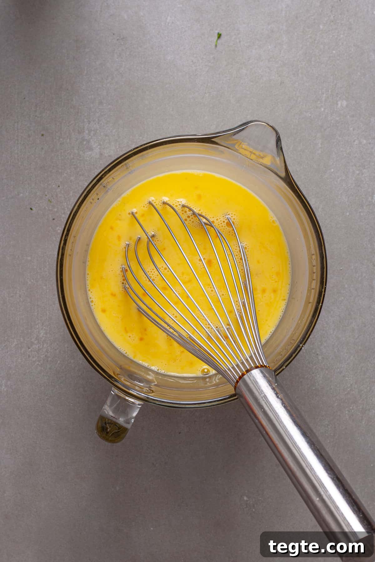 Egg s and milk whisked together in a  large measuring cup.