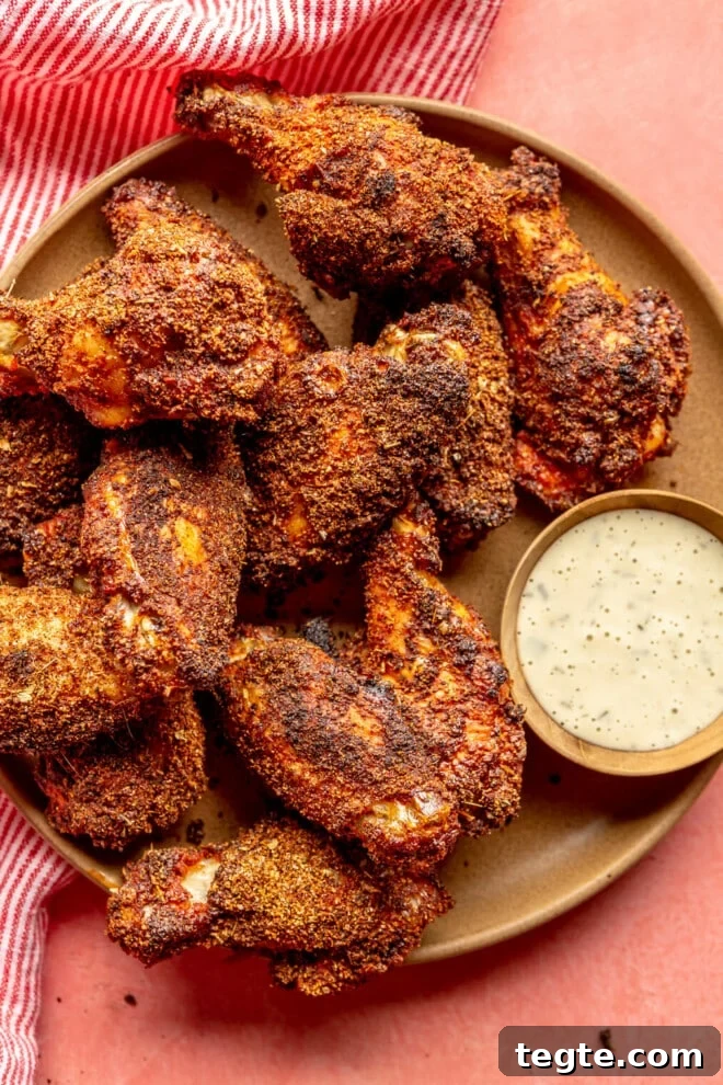 Crispy Dry Rub Chicken Wings Recipe for Perfect Flavor 2 Brown plate with dry rubbed chicken wings served next to a side of ranch dressing.