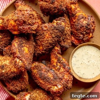 Crispy Dry Rub Chicken Wings Recipe for Perfect Flavor 7 Brown plate with dry rubbed chicken wings served next to a side of ranch dressing.