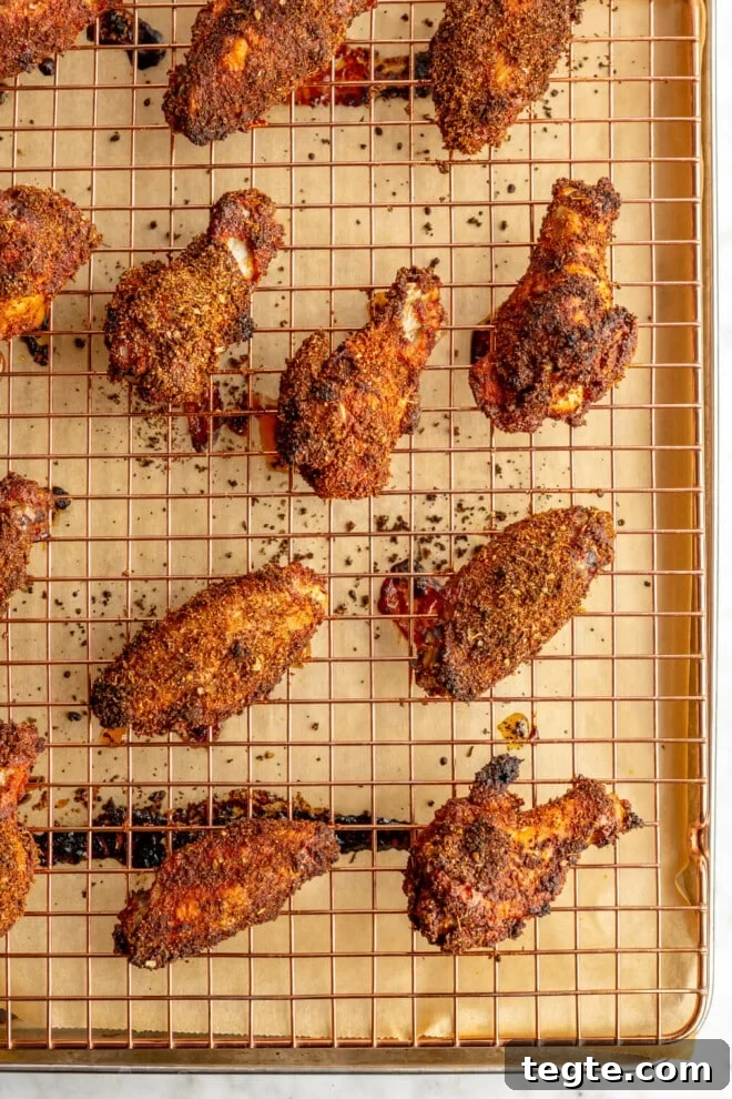 Crispy Dry Rub Chicken Wings Recipe for Perfect Flavor 3 Baked dry rub chicken wings on a sheet pan lined with parchment paper.