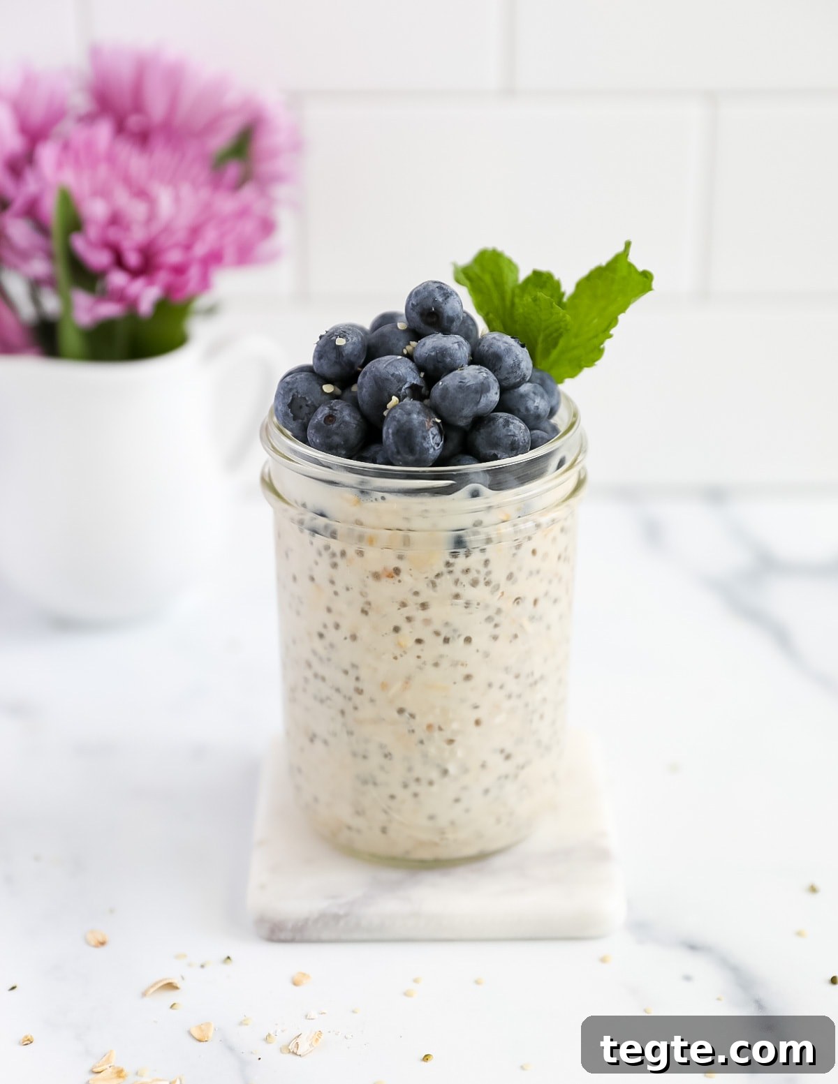 Creamy Chia Seed Overnight Oats Recipe for Quick Breakfast 2 A jar of oatmeal with blueberries and mint on top