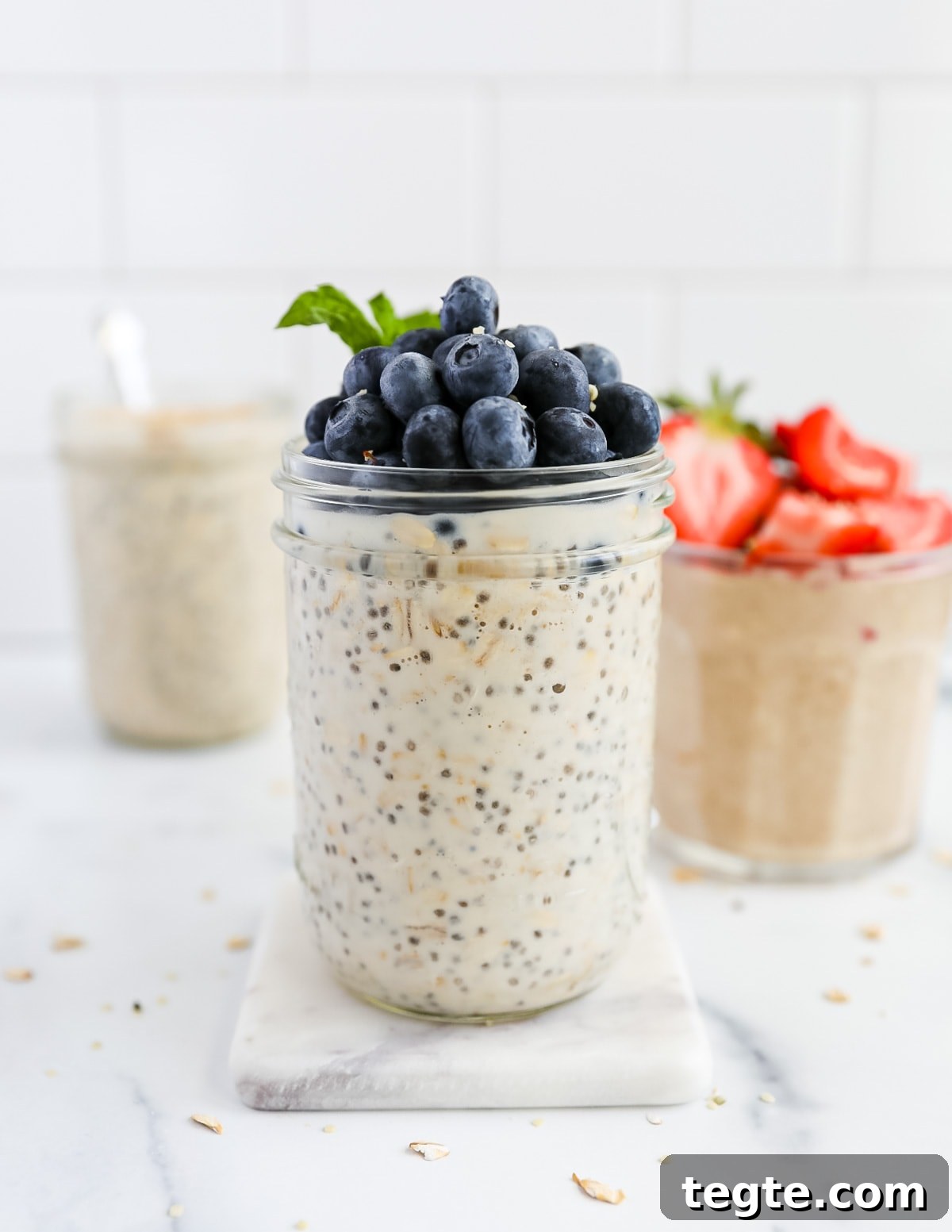 Creamy Chia Seed Overnight Oats Recipe for Quick Breakfast 5 Three jars filled with overnight oatmeal topped with fresh berries