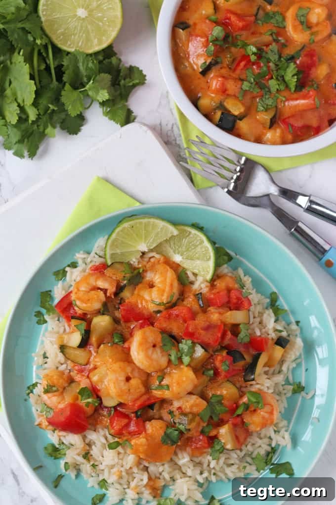 Spicy Thai Red Prawn Curry Recipe for Authentic Flavors 3 Thai Red Prawn Curry served on a blue plate with rice and two lime wedges