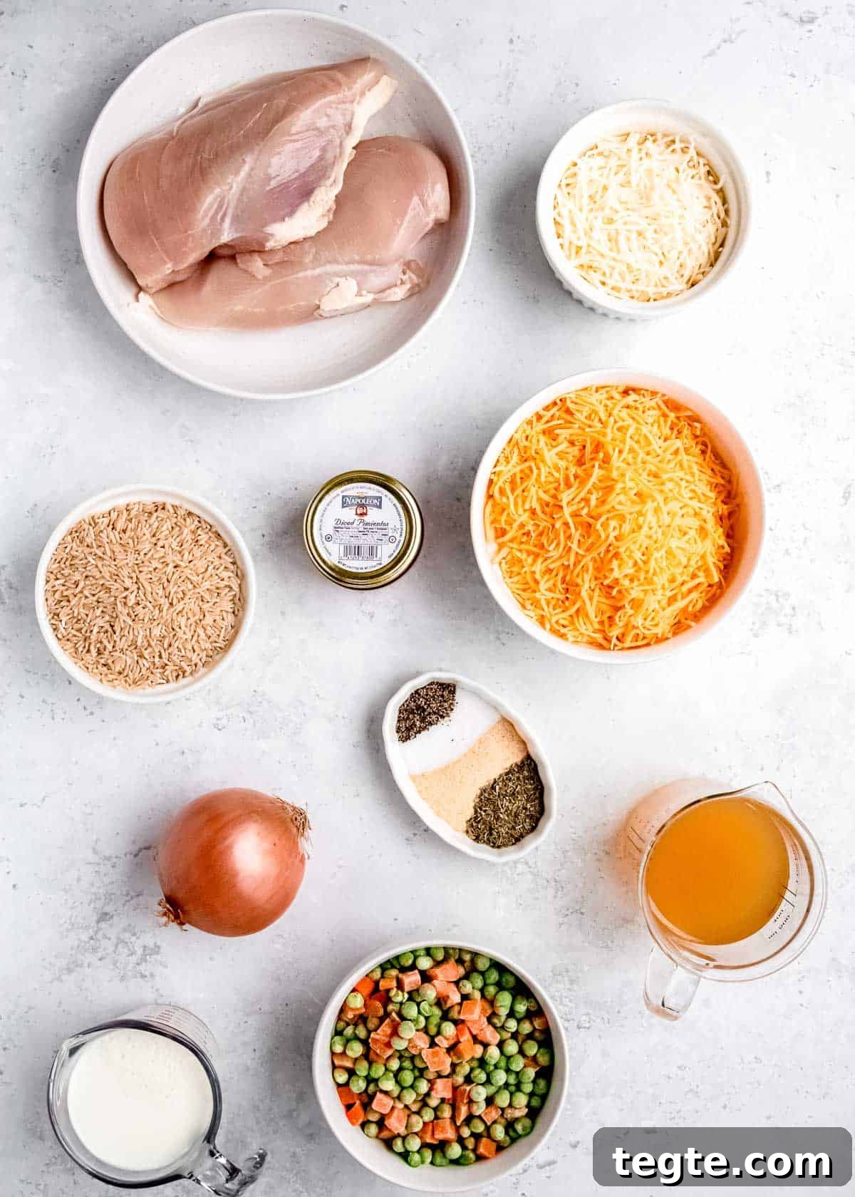 all individual ingredients for crockpot chicken and rice on a white background