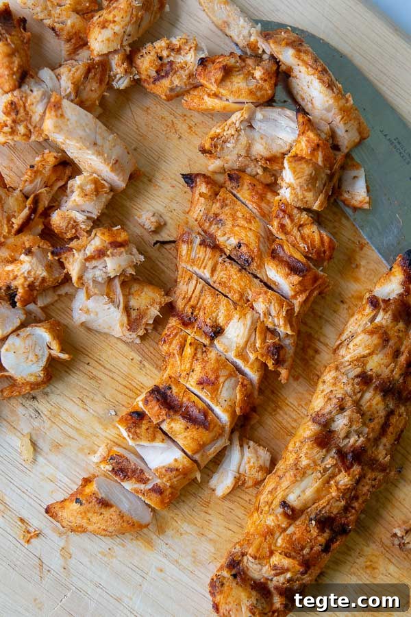 Grilled Buffalo Chicken Tacos with Tangy Slaw and Marinade 7 grilled buffalo chicken on a wooden cutting board sliced up