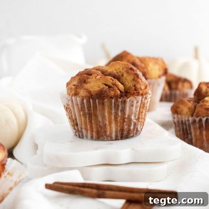 muffin on table with cinnamon sticks by it