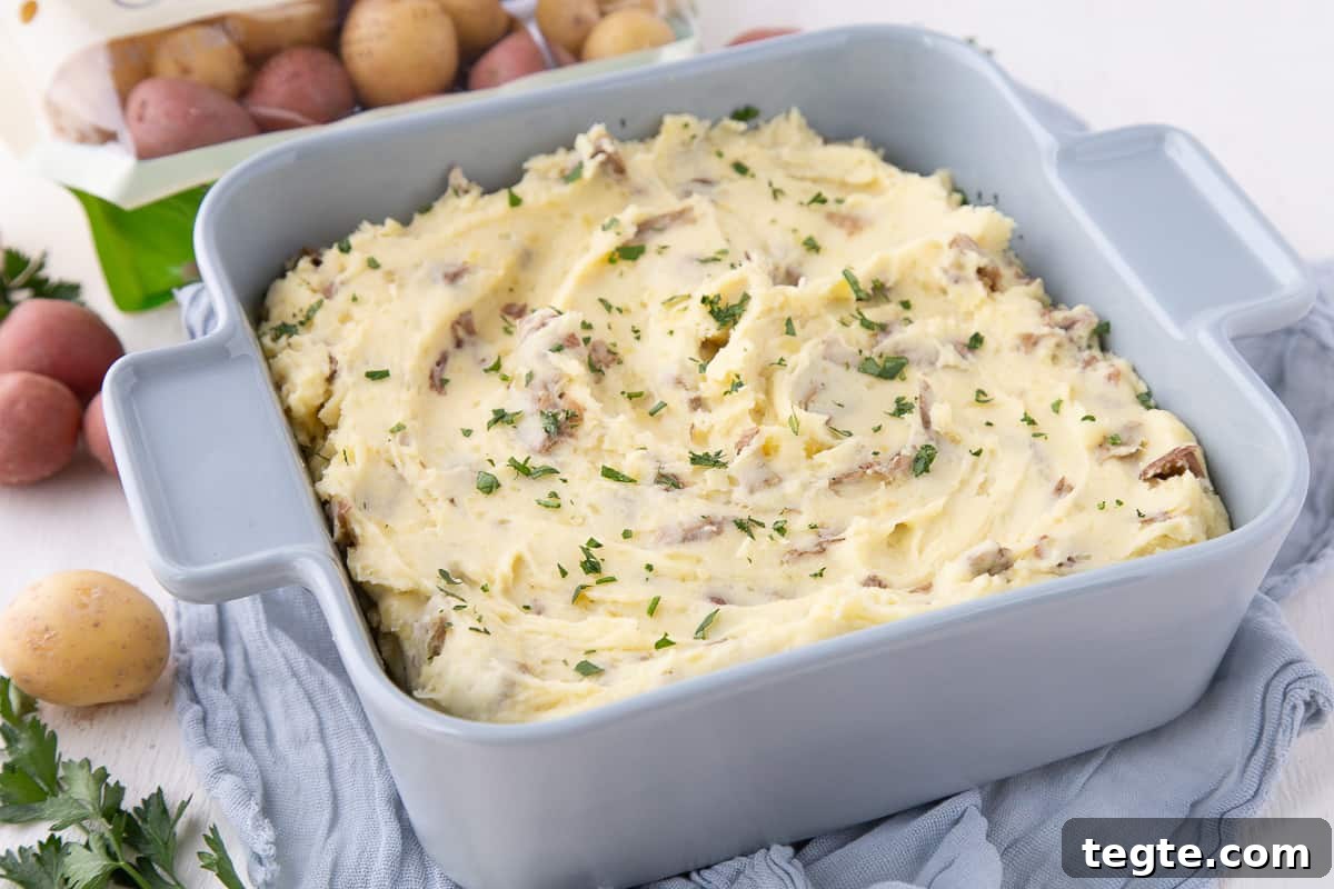Creamy Mashed Potato Casserole Without Peeling Potatoes 8 mashed potato casserole in a blue square dish.