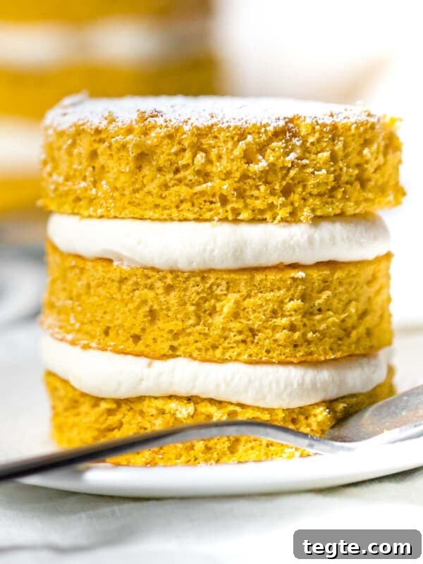 Authentic Japanese Strawberry Shortcake Recipe — Fluffy, Light Slice 12 close up of mini pumpkin layer cake with cream cheese frosting on a white plate