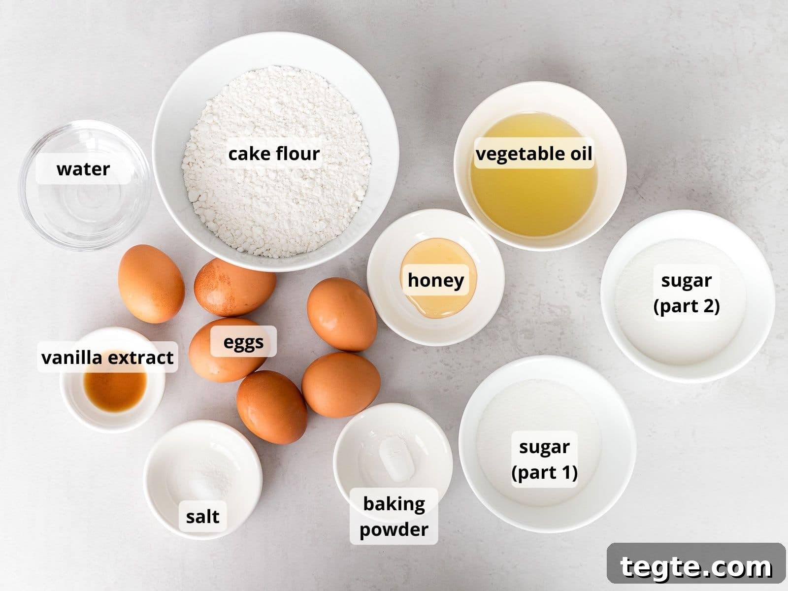 Authentic Japanese Strawberry Shortcake Recipe — Fluffy, Light Slice 6 labeled photo of ingredients for Japanese strawberry shortcake in white bowls that includes eggs, cake flour, and sugar