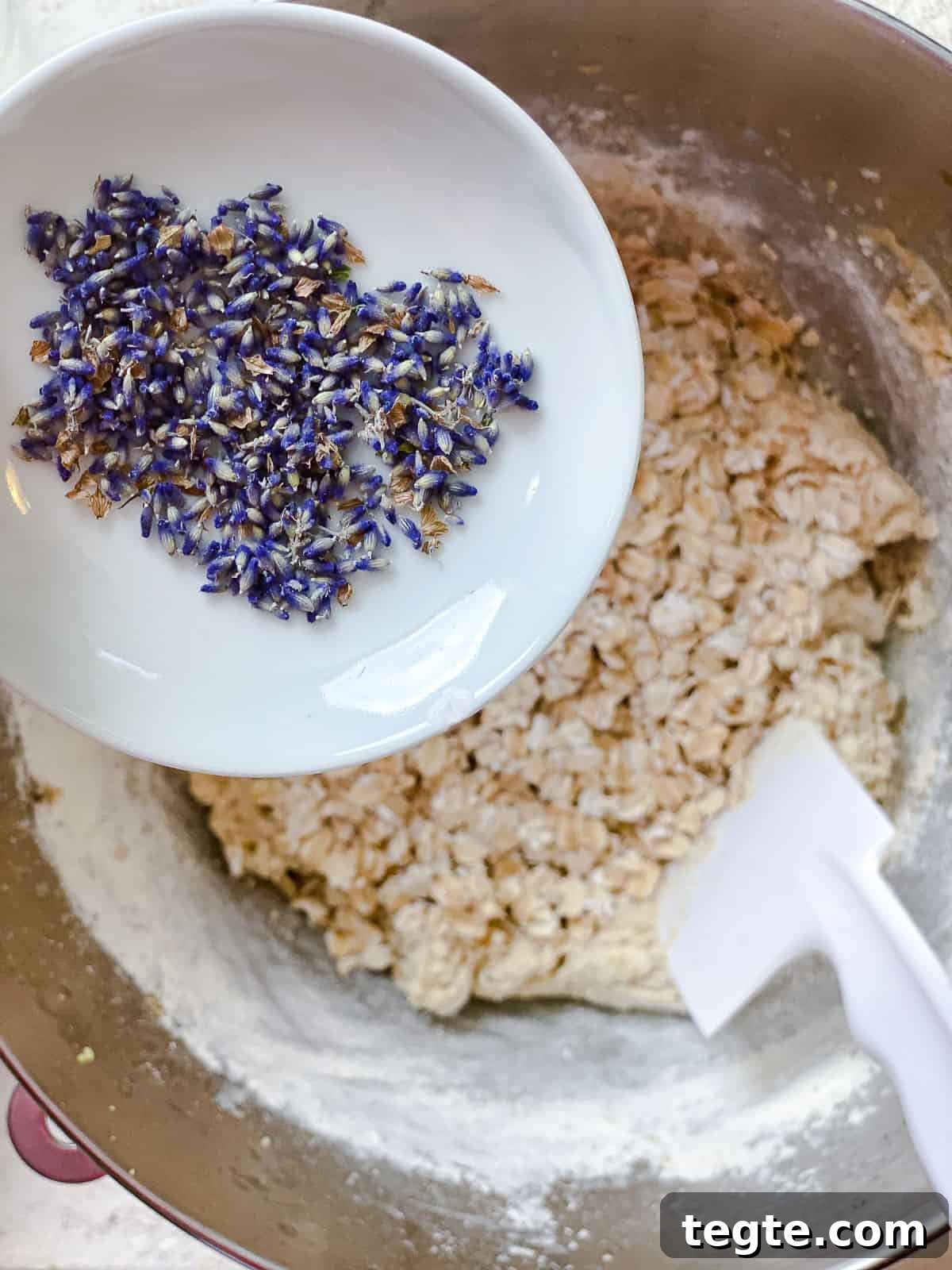 Lemon Lavender Cookie Recipe for Light, Fragrant Treats 6 process shot showing adding lavender to bowl of dough