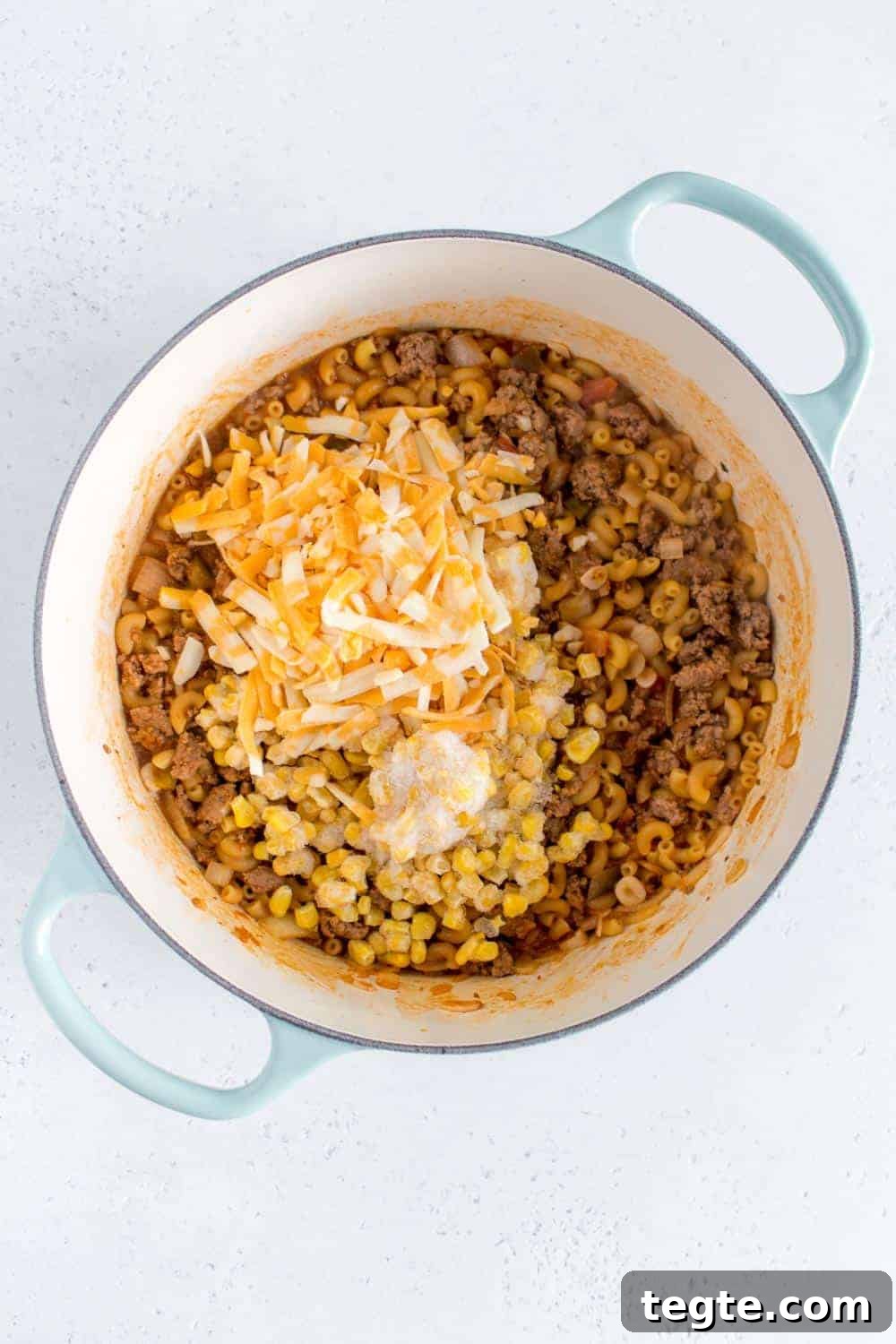 Cheese and corn added to salsa beef pasta.