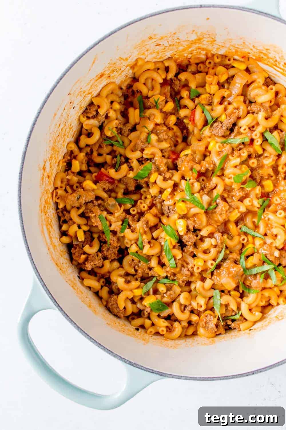 Close up view of a Dutch oven with cheesy beef salsa pasta.