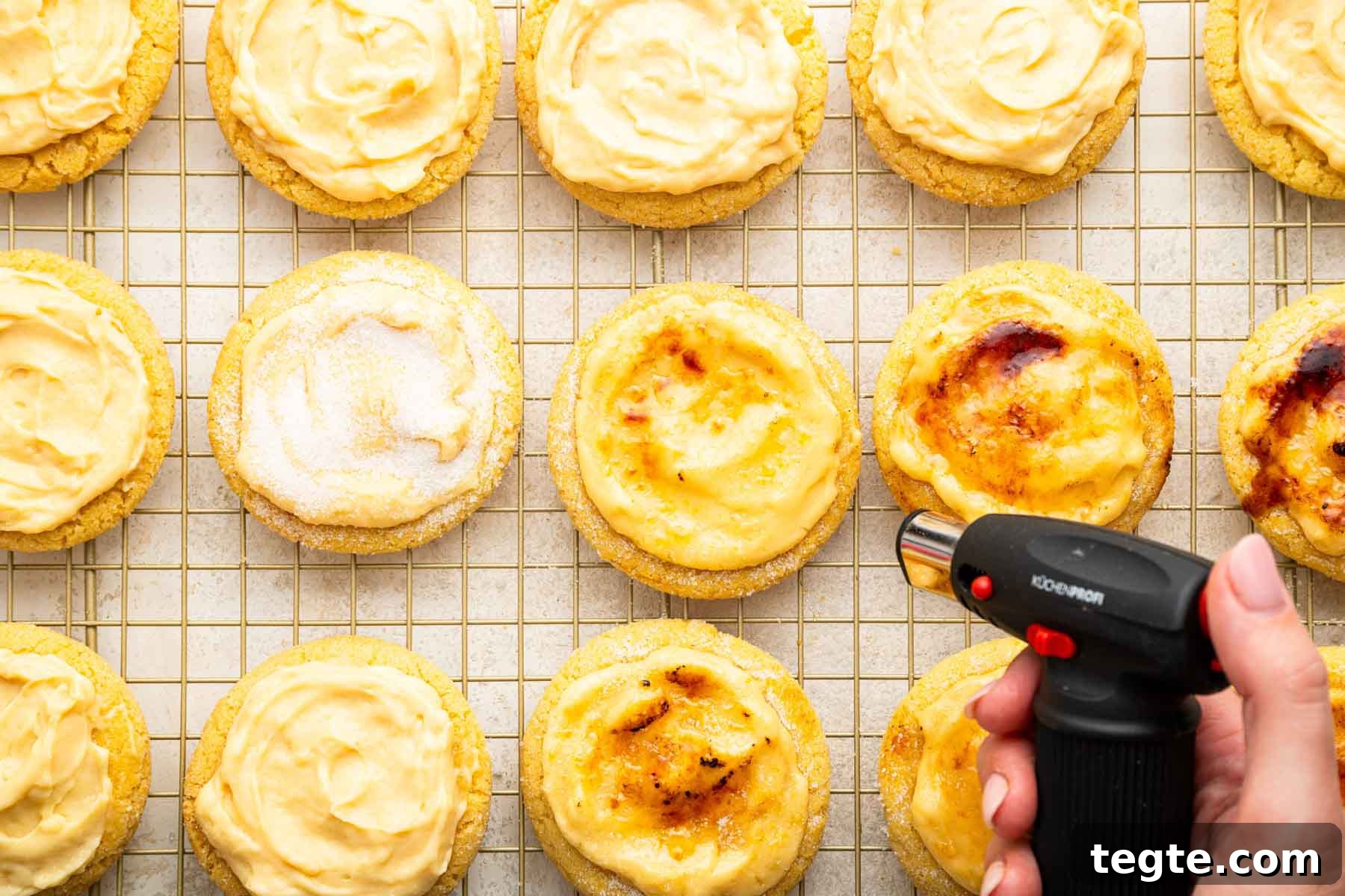 Crème Brûlée Cookies Recipe: Caramelized Sugar-Topped Cookie Treat 11 Hand using culinary torch to toast tops of cookies.