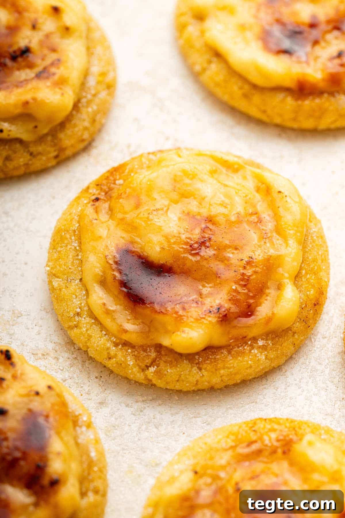 Crème Brûlée Cookies Recipe: Caramelized Sugar-Topped Cookie Treat 13 Macro shot of creme brulee sugar cookies on white surface.