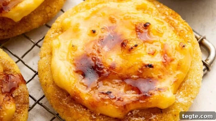 Creme brulee cookies with brown crispy topping on a wire rack.