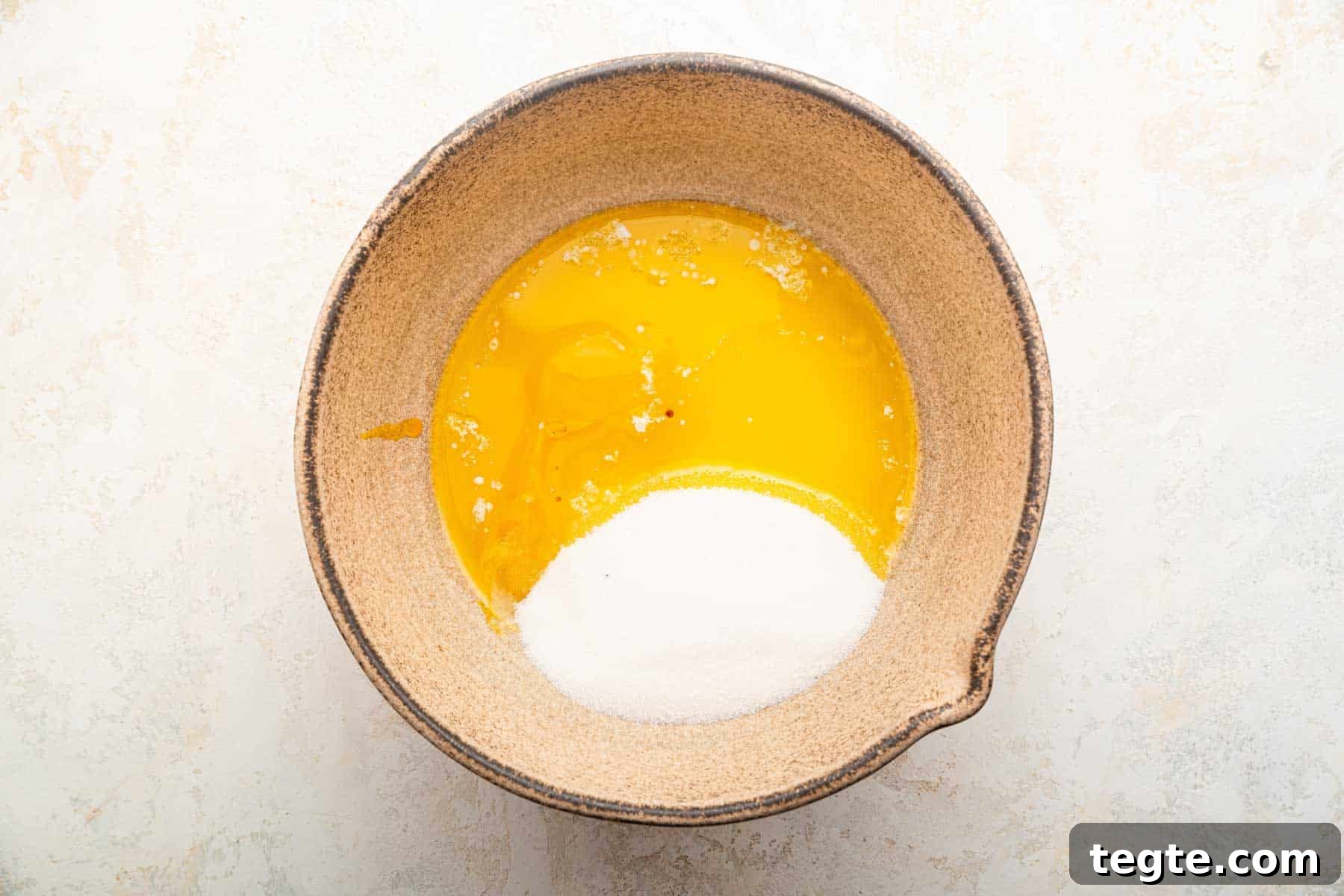 Crème Brûlée Cookies Recipe: Caramelized Sugar-Topped Cookie Treat 5 Melted butter, egg yolks and granulated sugar in a brown bowl.
