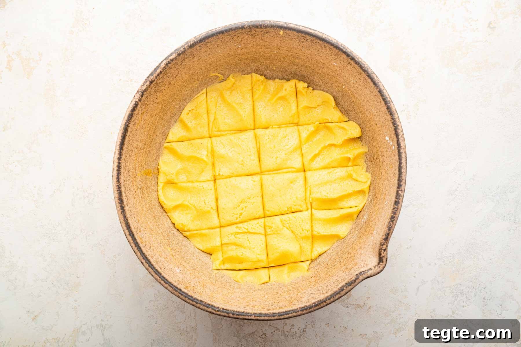 Crème Brûlée Cookies Recipe: Caramelized Sugar-Topped Cookie Treat 7 Yellow dough scored in a bowl into 12 servings.