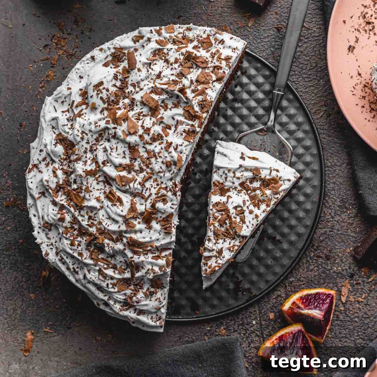 Dairy-Free Blood Orange Chocolate Cake Recipe 10 Overhead of blood orange chocolate cake with slices being removed.