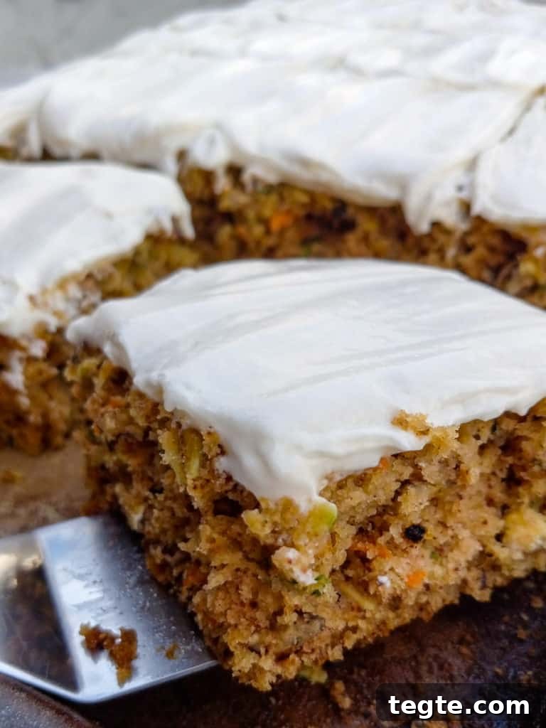 Zucchini Bars with Cream Cheese Frosting Recipe for Moist Dessert 6 scooping Amish zucchini bars on cookie sheet.