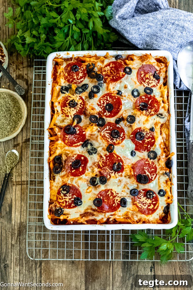 Our deliciously hearty pizza casserole will be kids of all ages will race to the dinner table when this is on the menu! Ooey-gooey, cheese YUM! #pizzacasserole #pizzapastacasserole pepperoni pizza casserole top shot