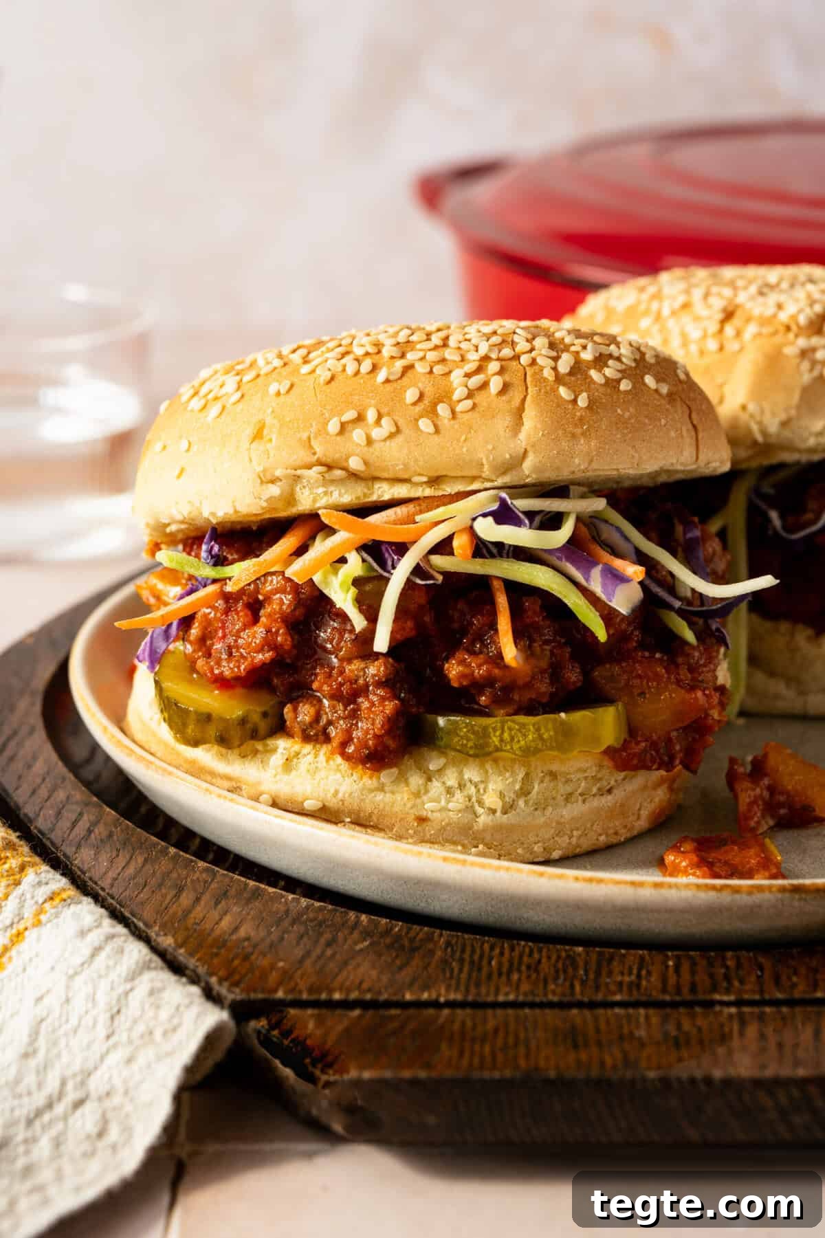 Lean Ground Beef Sloppy Joes with Tangy Tomato Sauce 2 Sloppy joes in a sesame seed bun topped with shredded cabbage.