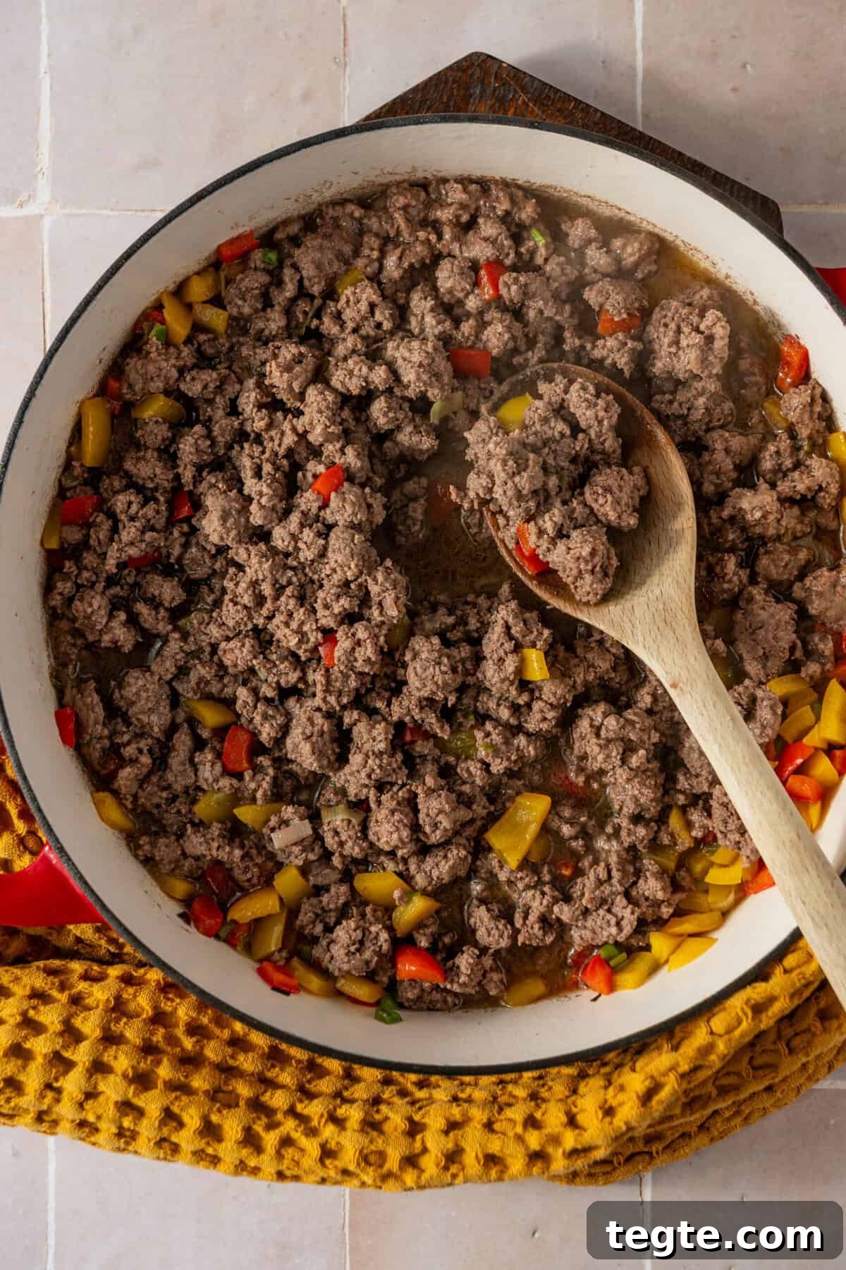 Lean Ground Beef Sloppy Joes with Tangy Tomato Sauce 7 A pan with chopped bell peppers and cooked ground beef in it.