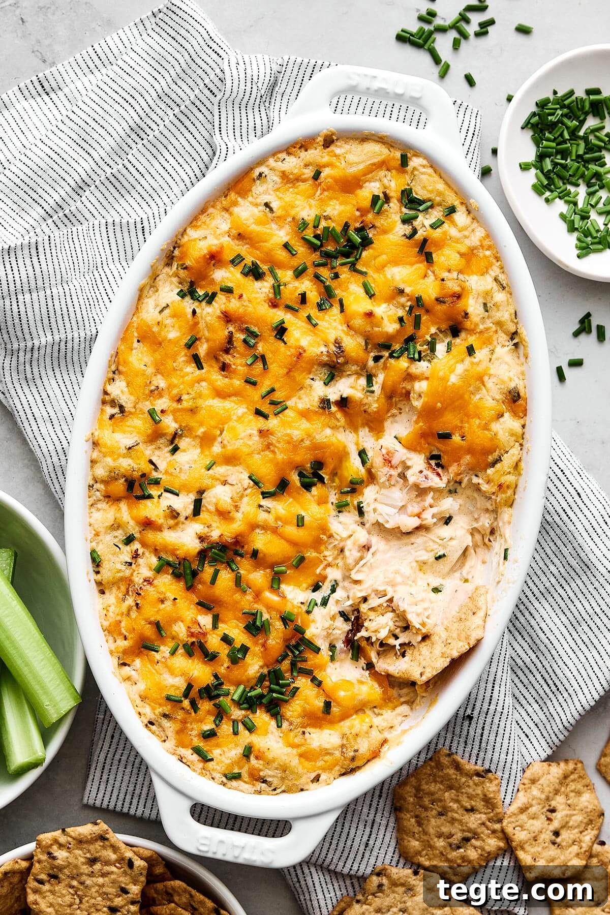 13 Festive Christmas Appetizers Your Guests Will Love 5 A baking dish with crab dip and crackers.
