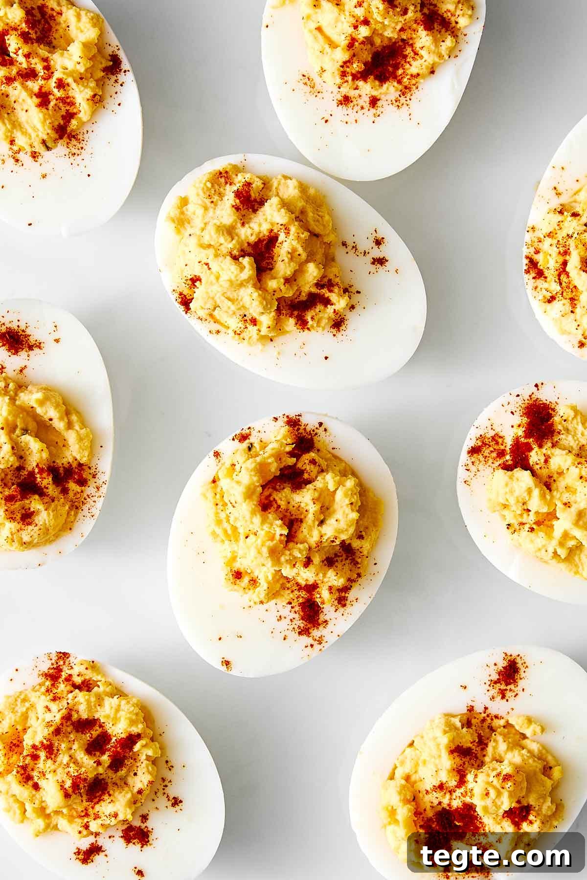13 Festive Christmas Appetizers Your Guests Will Love 6 Deviled eggs on a white plate.