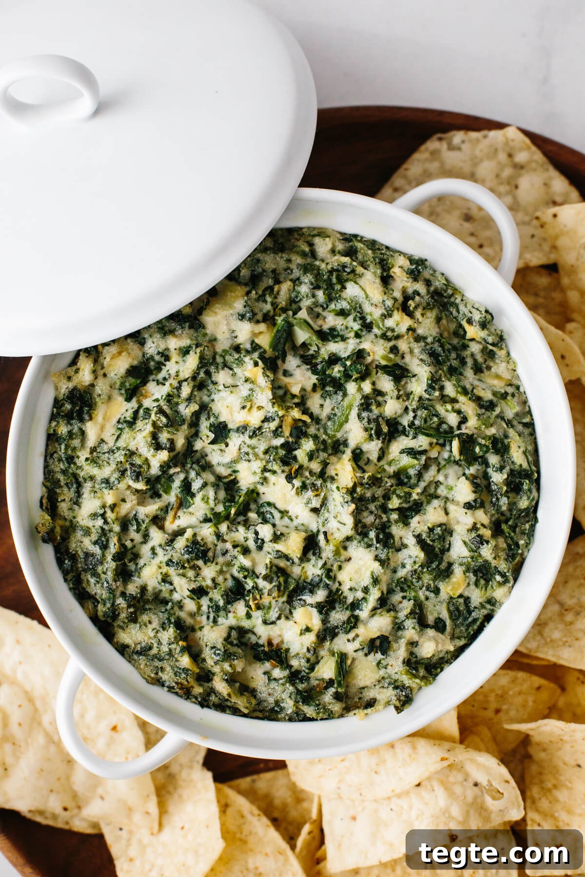 13 Festive Christmas Appetizers Your Guests Will Love 9 Spinach artichoke dip in a white casserole dish.
