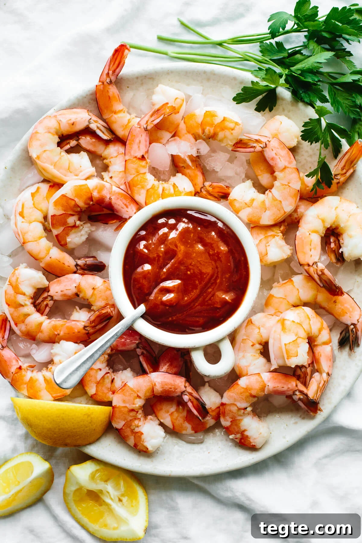 13 Festive Christmas Appetizers Your Guests Will Love 10 Shrimp cocktail on a platter with sauce.
