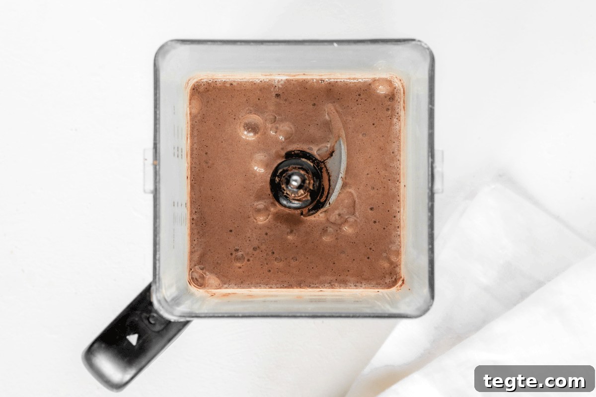 A chocolate banana smoothie in a blender