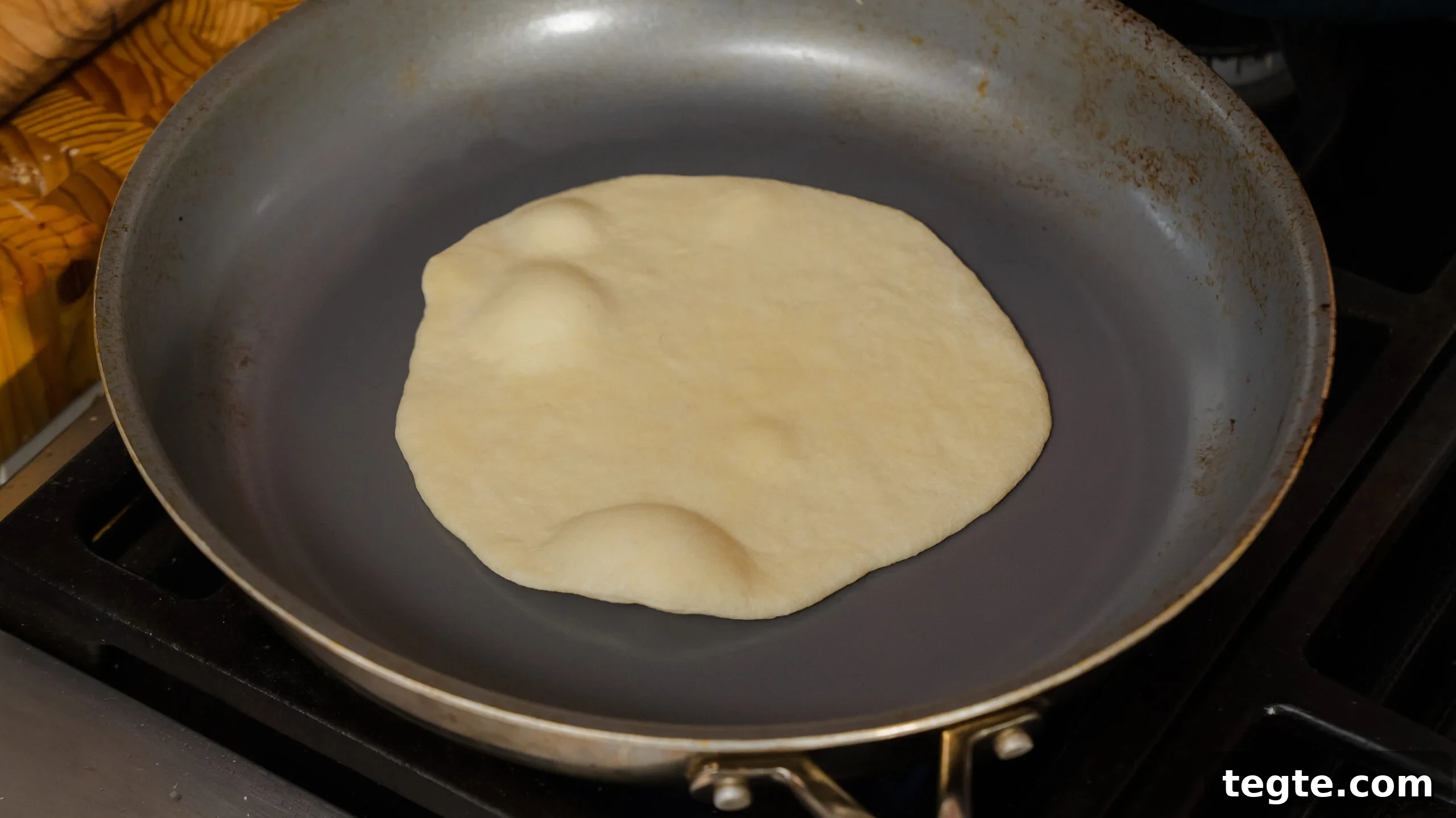 Homemade Flour Tortillas Made with 5 Simple Ingredients 4 a flour tortilla being cooked in a hot pan.