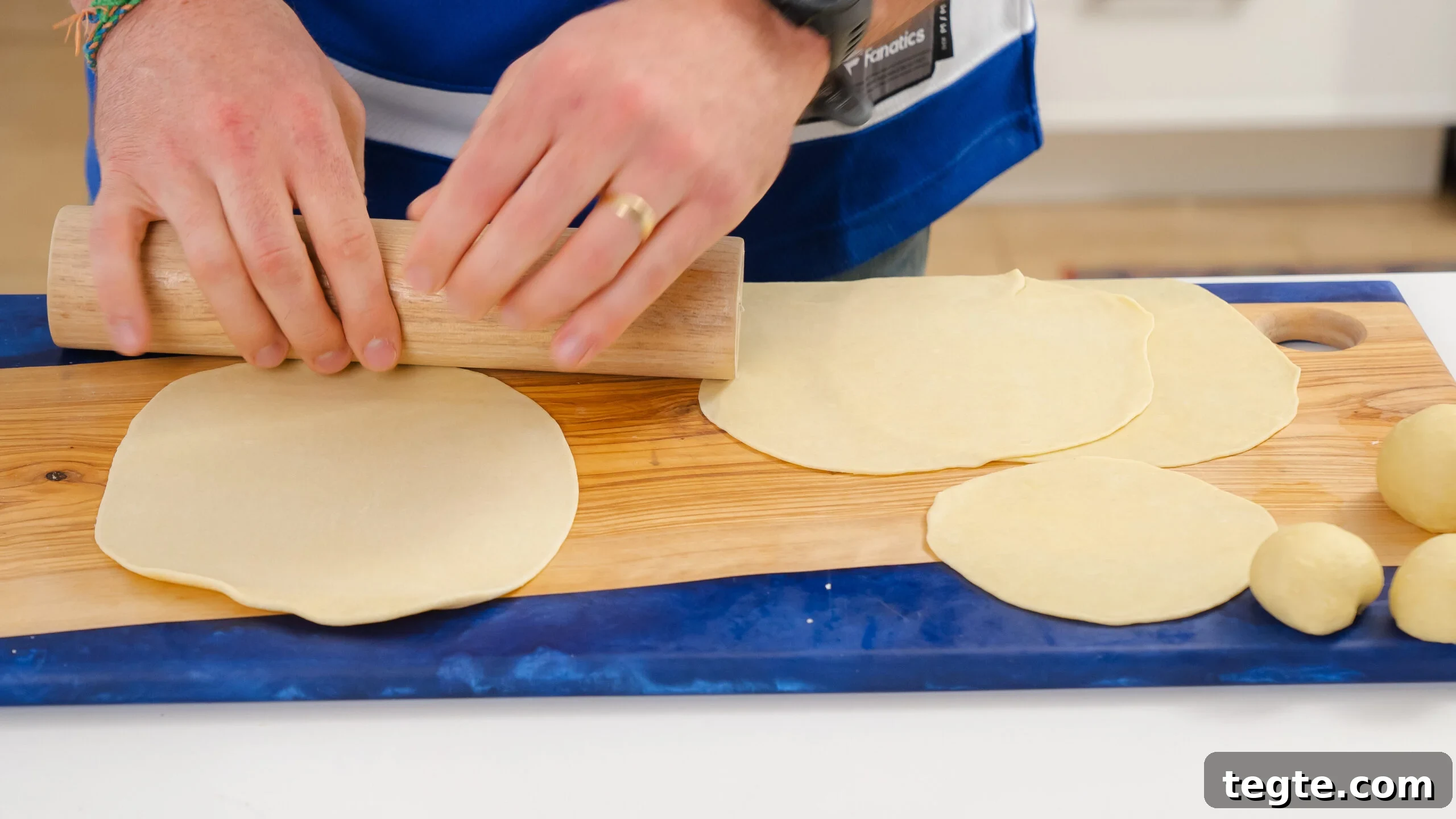 Homemade Flour Tortillas Made with 5 Simple Ingredients 5 A delicious homemade flour tortilla recipe with someone rolling out the dough on a cutting board.