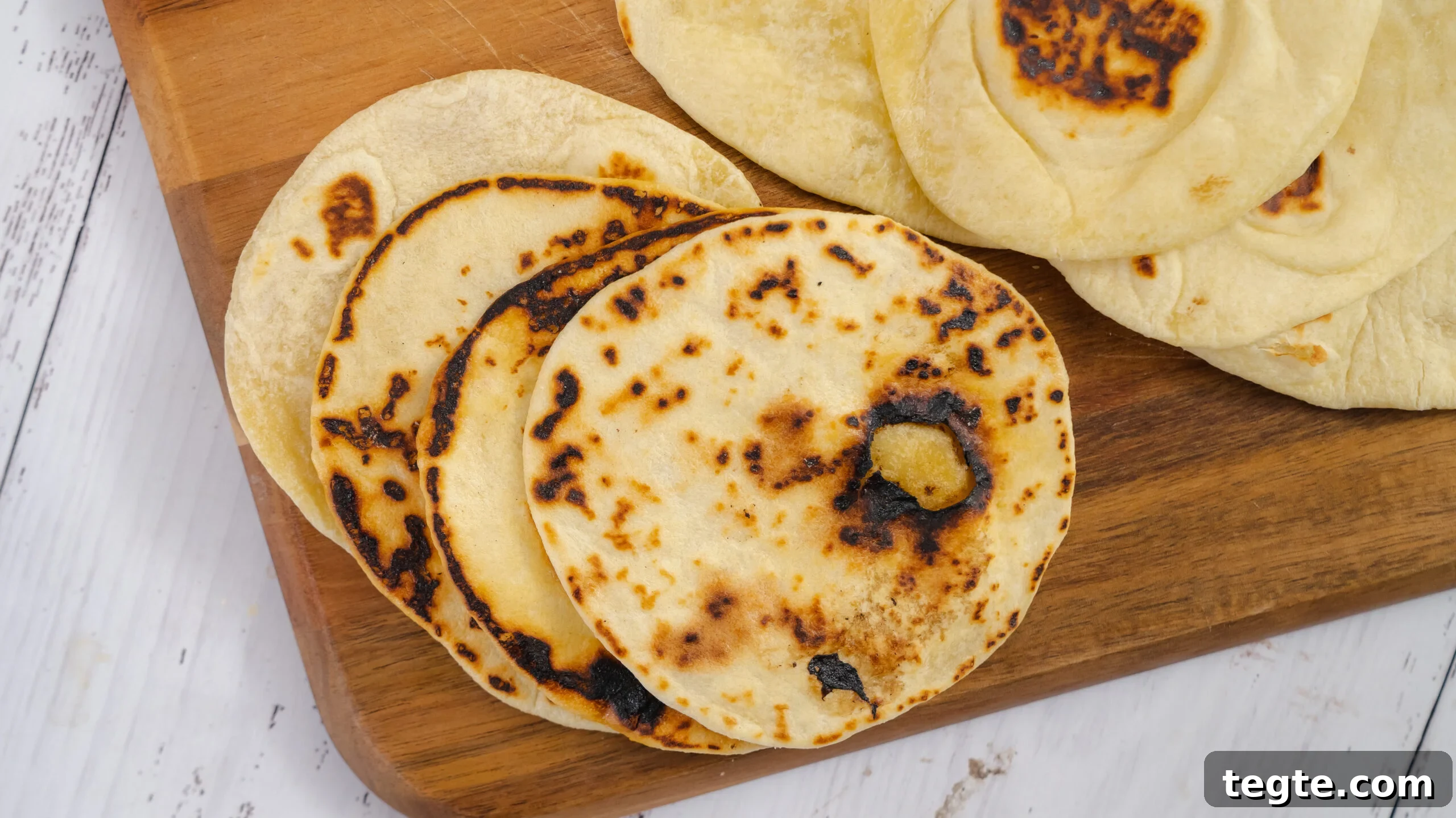 Homemade Flour Tortillas Made with 5 Simple Ingredients 7 Homemade flour tortilla recipe with flour tortillas on a cutting board.