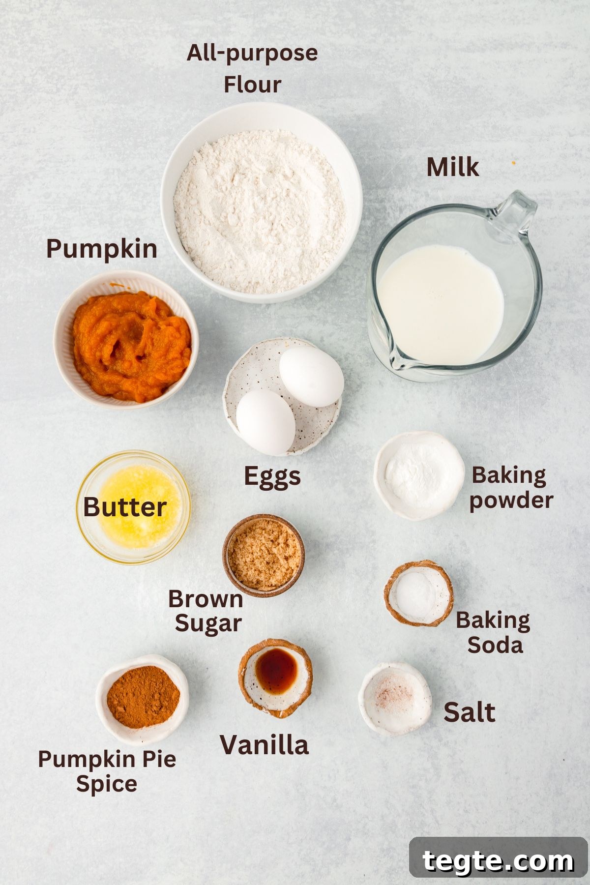 Pumpkin Pie Spice Pancakes: Fluffy Fall Breakfast Recipe 3 Flour, milk, eggs, butter, pumpkin puree, brown sugar, vanilla, baking powder, baking soda, salt, pumpkin pie spice ingredient layout.