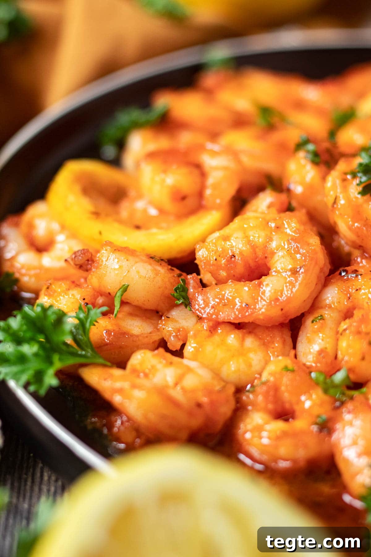 close up of cajun honey butter shrimp on black plate