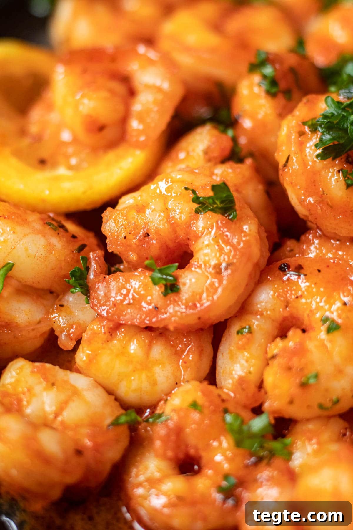 close up of cajun honey butter shrimp on black plate