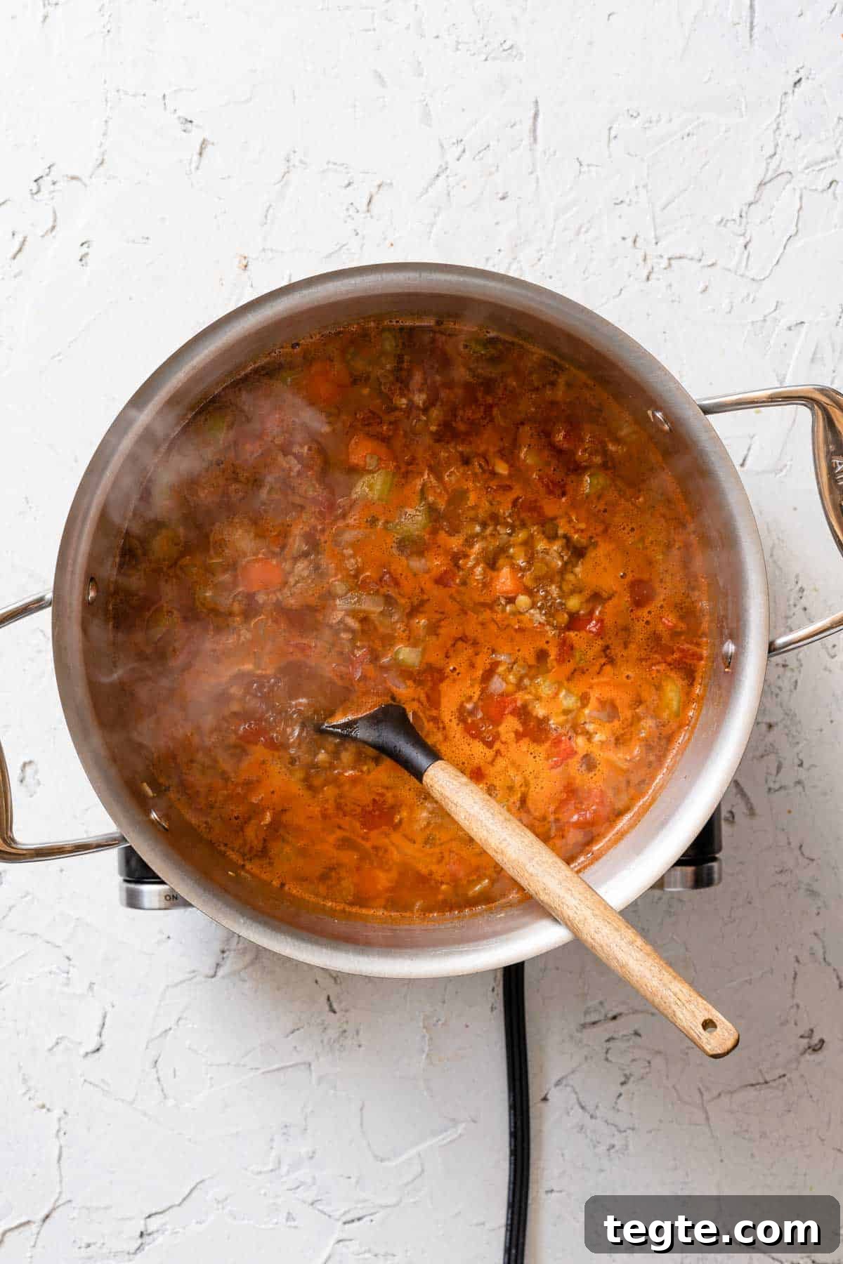 lentil turkey soup simmering in large soup pot